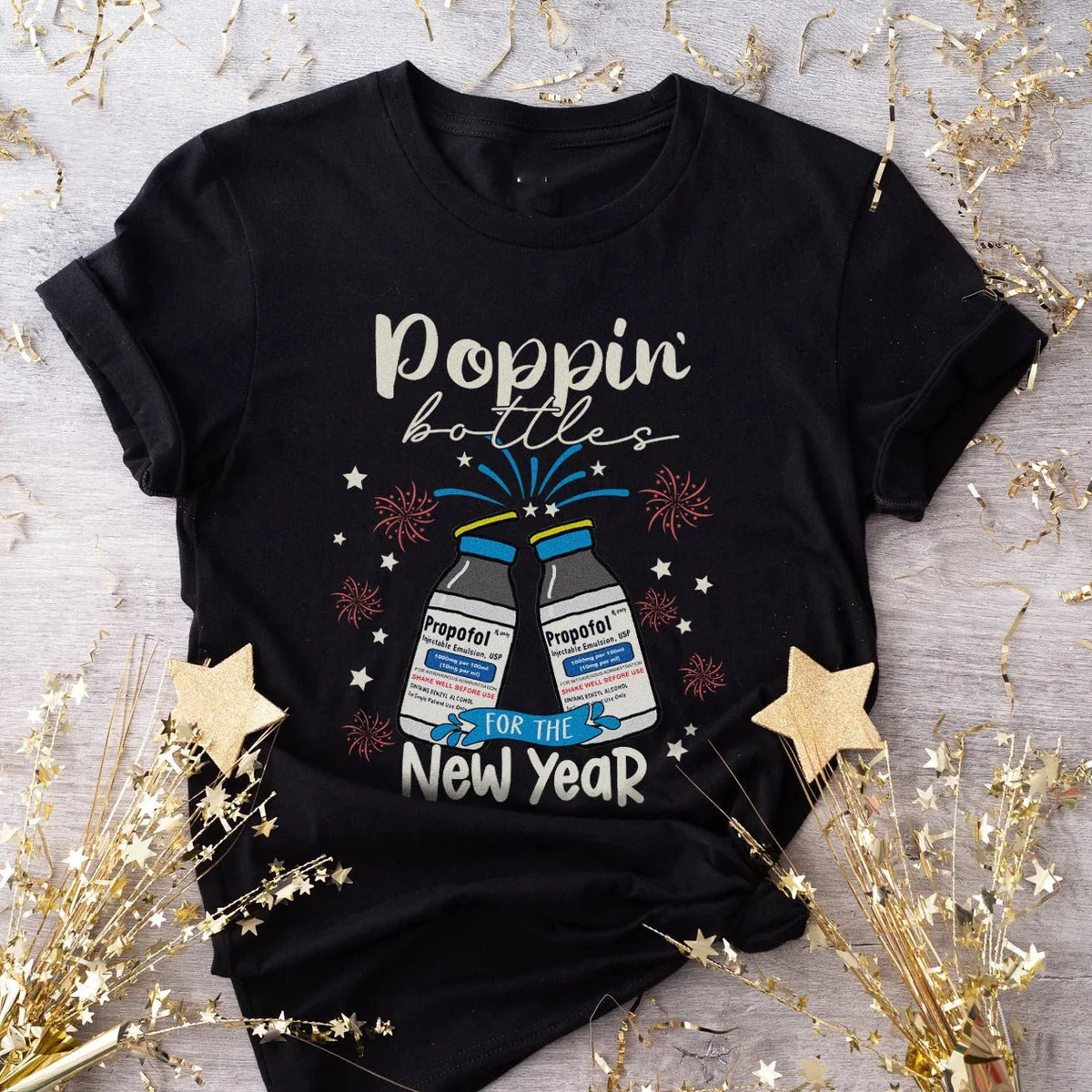 Celebrate in chic style with our Poppin Bottle New Year T-shirt in classic black. Cheers to fashion