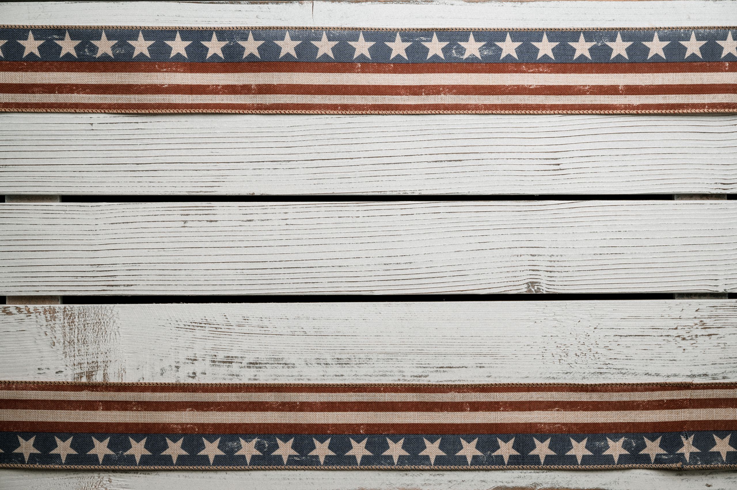 Textured wooden panels featuring a vintage American flag design with stars and stripes.